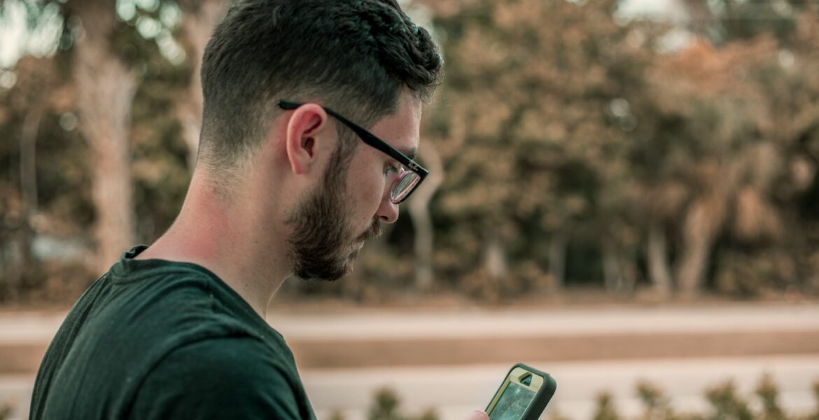 man looking down on his phone
